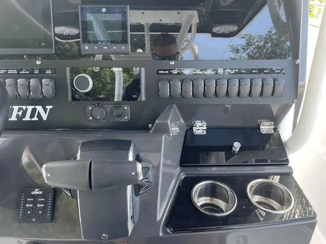 Slide: The Image of Control panel of a 2023 Blackfin 272CC boat with switches and cup holders. - 10