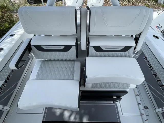 Slide: The Image of 2023 Blackfin 272CC boat with luxurious white seating and diamond-stitched upholstery. - 14
