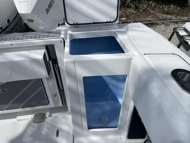 Slide: The Image of 2023 Blackfin 272CC boat with open storage compartments and seating. - 16