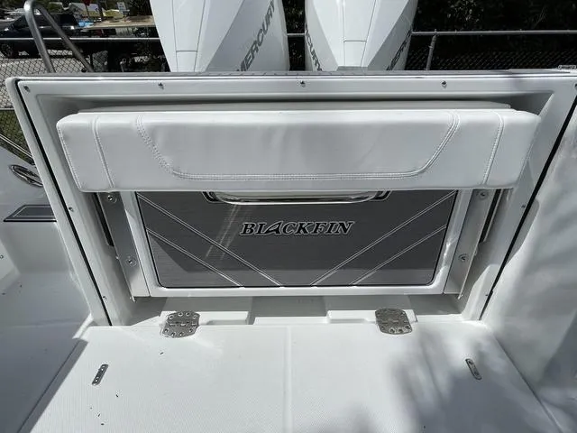 Slide: The Image of 2023 Blackfin 272CC boat with fold-down seat and storage compartment. - 17