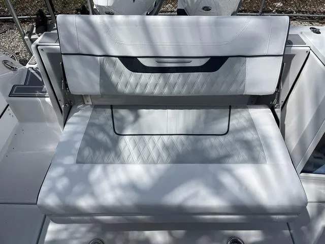 Slide: The Image of 2023 Blackfin 272CC boat with white cushioned seating. - 18