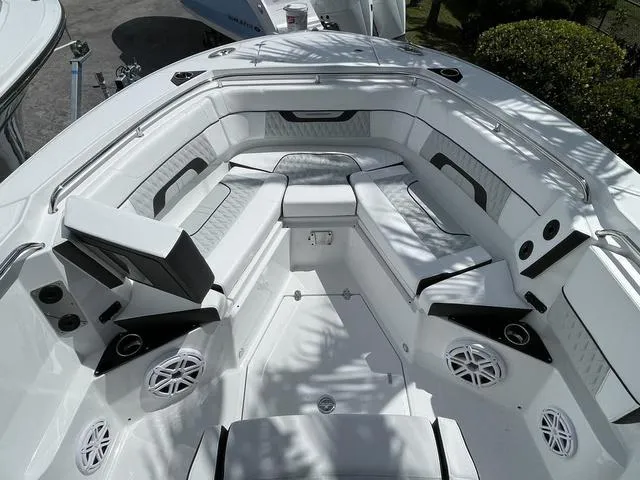 Slide: The Image of 2023 Blackfin 272CC boat interior with white seating and built-in speakers. - 20