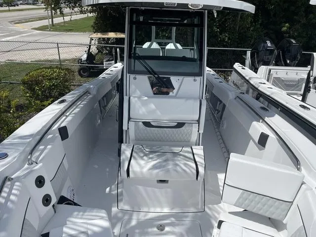 Slide: The Image of 2023 Blackfin 272CC center console boat interior, white seating, and storage compartments. - 24