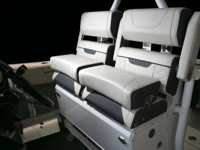 Slide: The Image of 2023 Blackfin 272CC boat interior seating with luxurious white and black upholstery. - 33