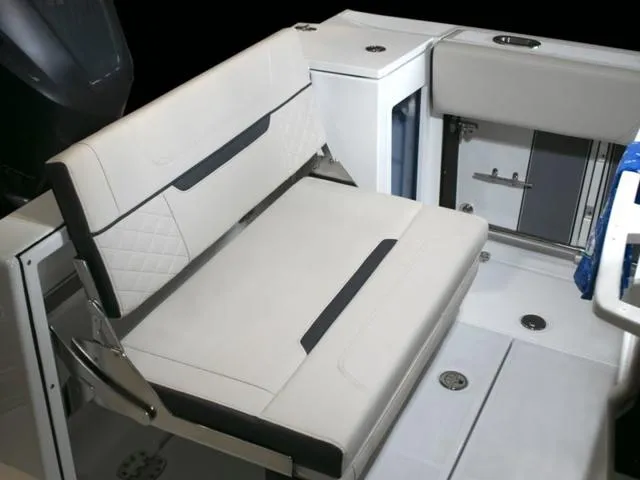 Slide: The Image of 2023 Blackfin 272CC boat interior with cushioned seating and storage compartments. - 34