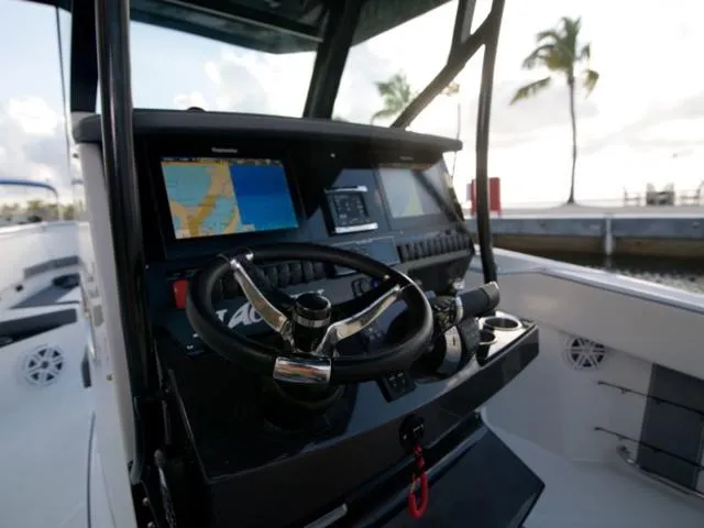 Slide: The Image of 2023 Blackfin 272CC boat dashboard with navigation screens and steering wheel. - 39