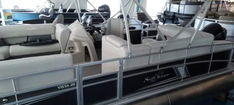 The Image of 2024 SunChaser Vista 20 CRB pontoon boat in showroom. - 0