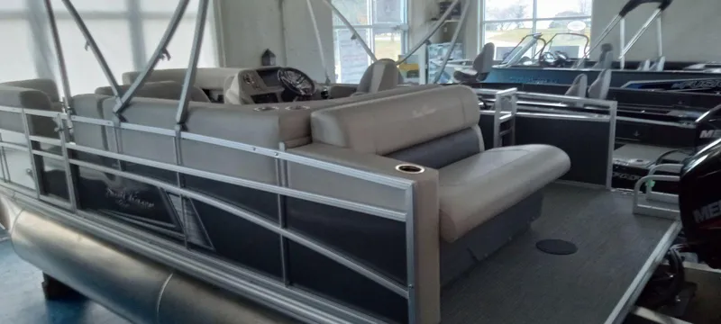 Slide: The Image of 2024 SunChaser Vista 20 CRB pontoon boat interior with seating and control console. - 3