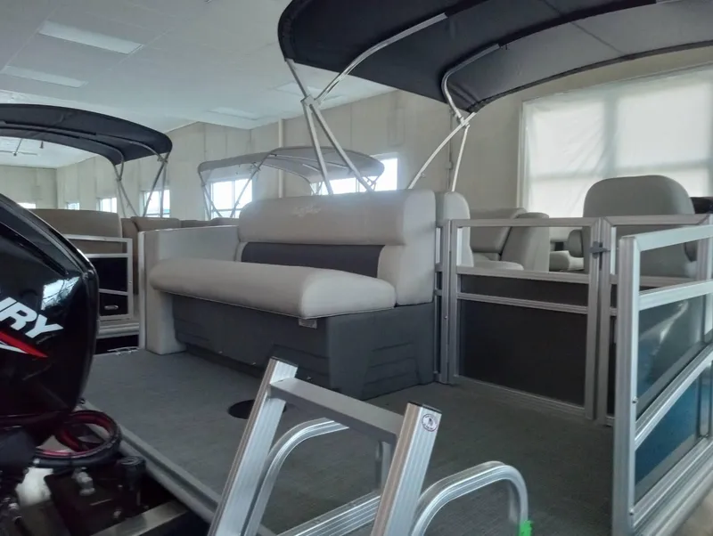 Slide: The Image of 2024 SunChaser Vista 20 CRB pontoon boat interior with seating and canopy. - 4