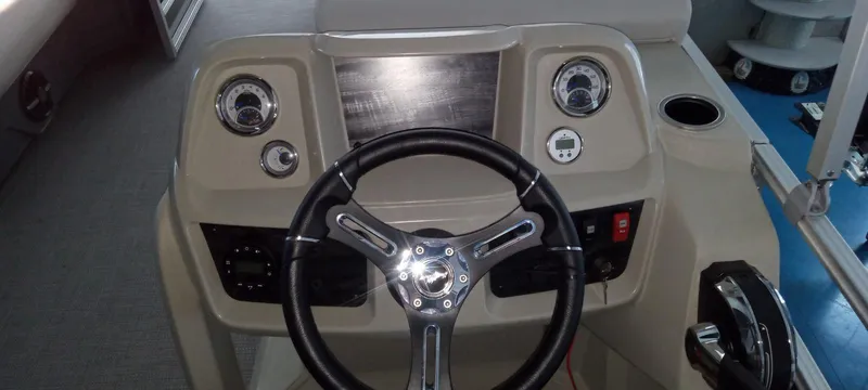 Slide: The Image of 2024 SunChaser Vista 20 CRB boat dashboard with steering wheel and control panel. - 5