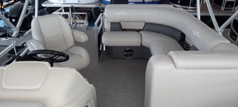 Slide: The Image of 2024 SunChaser Vista 20 CRB pontoon boat interior with plush seating and steering console. - 6