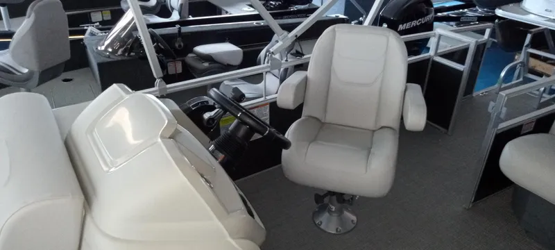 Slide: The Image of 2024 SunChaser Vista 20 CRB boat interior with captain's chair and steering console. - 8