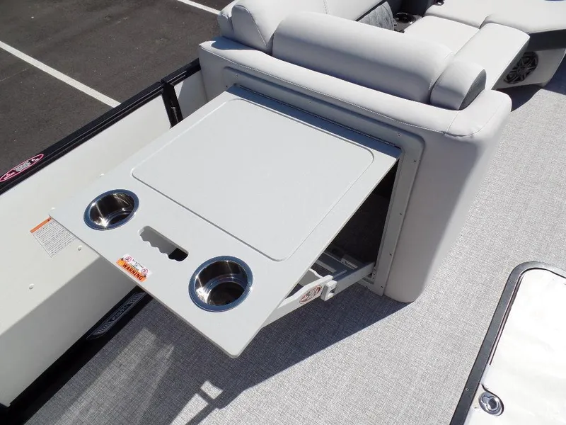 Slide: The Image of 2024 Harris Sunliner 230 boat with fold-out table and cup holders. - 10