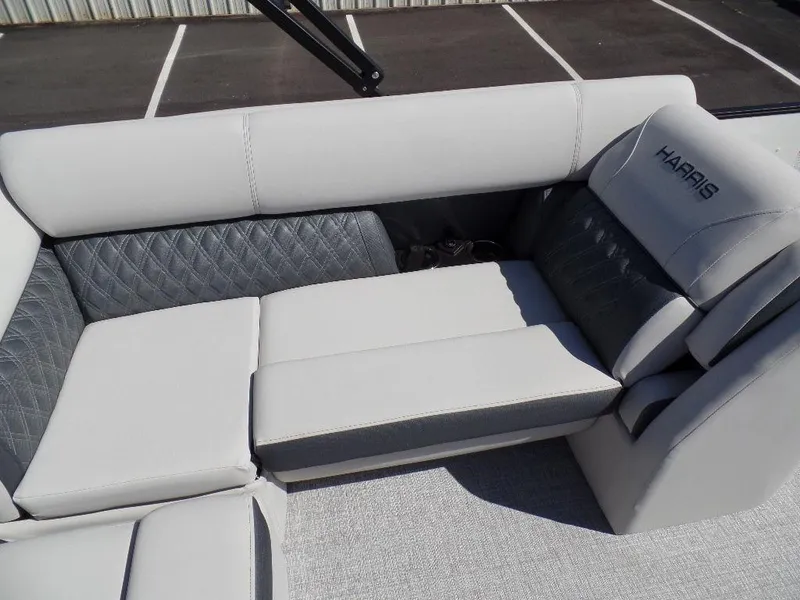 Slide: The Image of 2024 Harris Sunliner 230 boat interior with gray and white cushioned seating. - 12