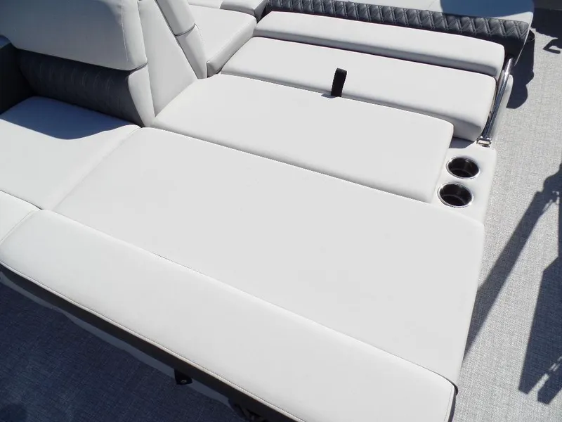 Slide: The Image of 2024 Harris Sunliner 230 boat with luxurious white seating and cup holders. - 15
