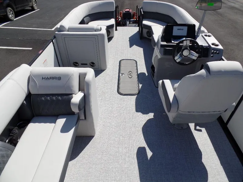 Slide: The Image of 2024 Harris Sunliner 230 pontoon boat interior with luxurious seating and modern helm. - 5