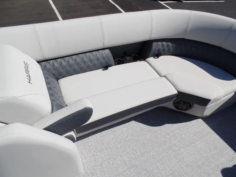 Slide: The Image of 2024 Harris Sunliner 230 boat interior with plush seating and cup holders. - 7