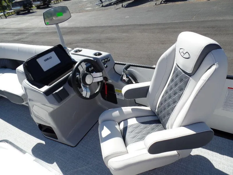 Slide: The Image of 2024 Harris Sunliner 230 boat interior with captain's chair and control console. - 8