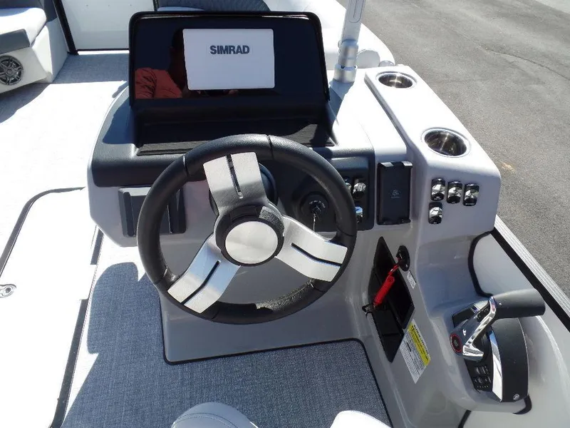 Slide: The Image of 2024 Harris Sunliner 230 boat helm with Simrad display and modern controls. - 9