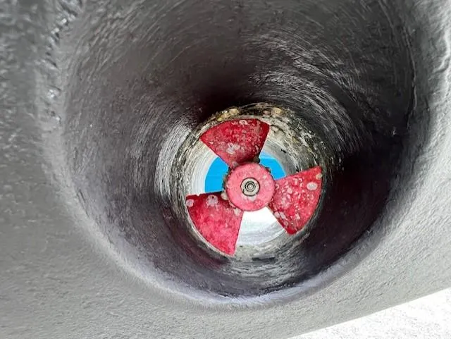 Slide: The Image of Close-up of a 2002 Grady-White 330 Express boat's red propeller in a tunnel. - 37