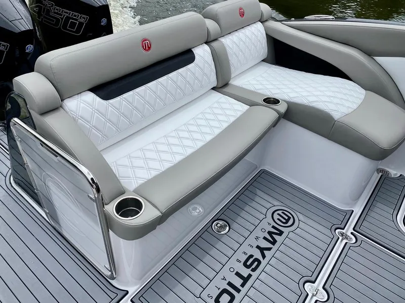 Slide: The Image of Luxurious seating on 2020 Mystic Powerboats M4200 with diamond-stitched upholstery and cup holders. - 10