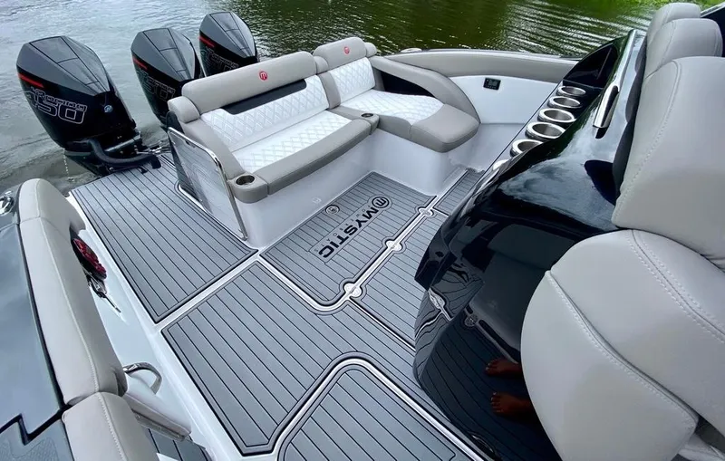 Slide: The Image of 2020 Mystic Powerboats M4200 interior with luxurious seating and powerful outboard engines. - 12