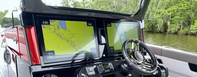 Slide: The Image of Dashboard of a 2020 Mystic Powerboats M4200 with navigation screens and steering wheel. - 15