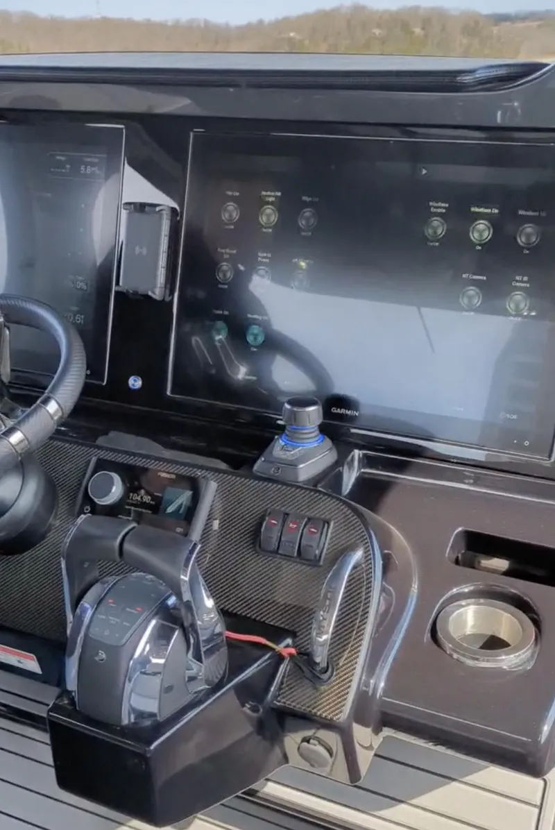 Slide: The Image of Control panel of a 2020 Mystic Powerboats M4200, featuring advanced navigation and steering systems. - 16