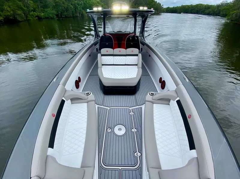 Slide: The Image of 2020 Mystic Powerboats M4200 on a serene river, showcasing luxurious seating and sleek design. - 23