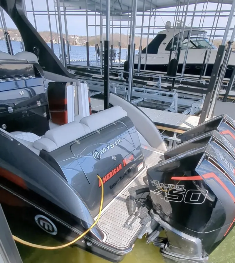 Slide: The Image of 2020 Mystic Powerboats M4200 with powerful engines docked in a marina. - 3