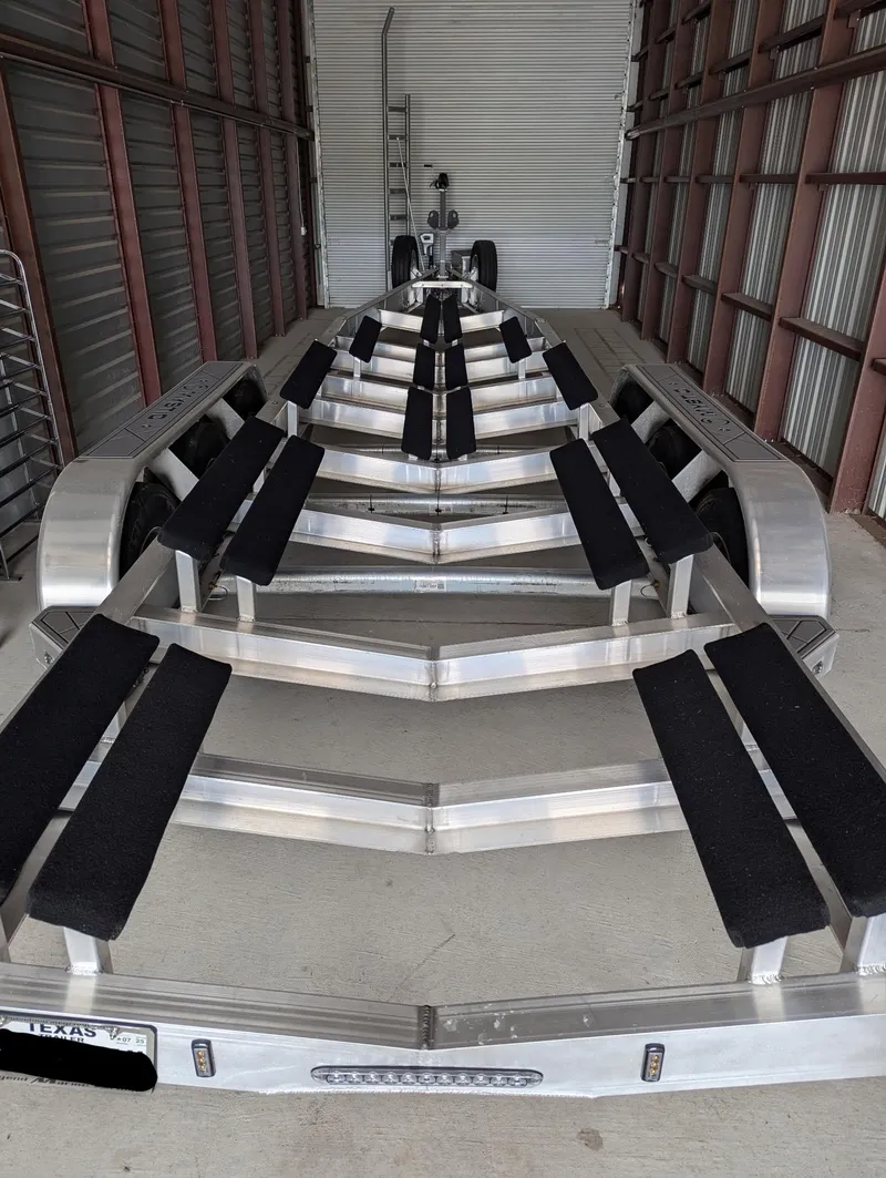 Slide: The Image of 2020 Mystic Powerboats M4200 trailer in storage, featuring multiple padded supports. - 41