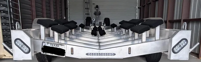 Slide: The Image of Trailer for 2020 Mystic Powerboats M4200, stored indoors, Texas license plate visible. - 42