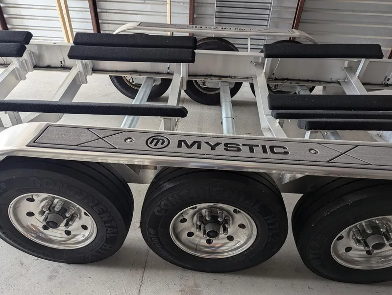 Slide: The Image of Trailer for 2020 Mystic Powerboats M4200 with multiple wheels and padded supports. - 45