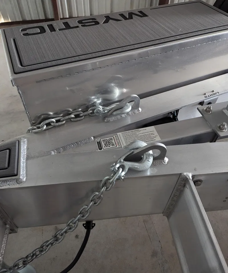 Slide: The Image of 2020 Mystic Powerboats M4200 trailer with chains and hooks in a storage area. - 49