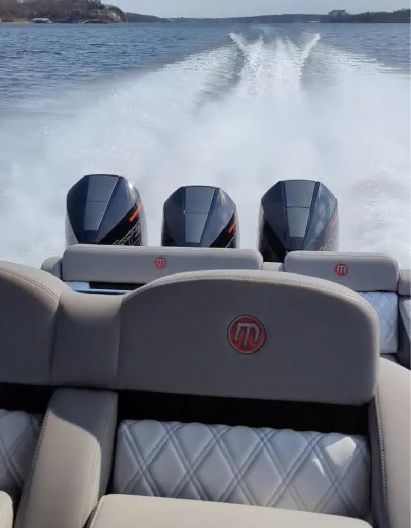Slide: The Image of 2020 Mystic Powerboats M4200 speeding on water, showcasing powerful triple engines. - 6