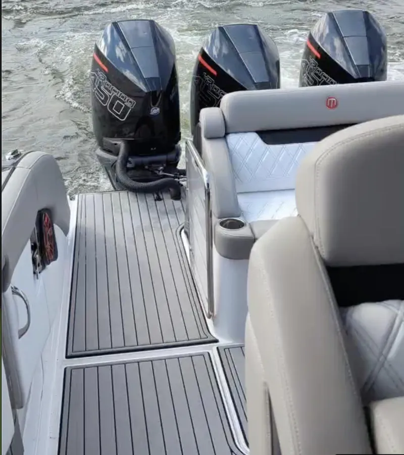 Slide: The Image of 2020 Mystic Powerboats M4200 with triple outboard engines on a sleek deck. - 8