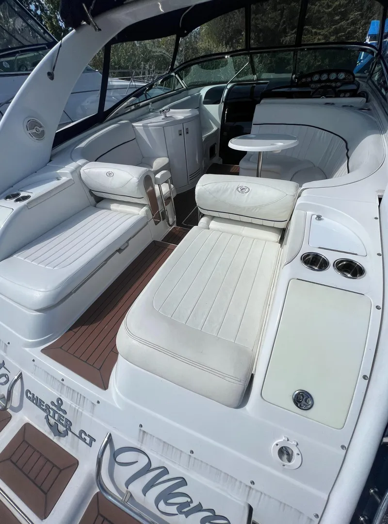 Slide: The Image of 2003 Cobalt 360 boat interior with white seating and wood accents. - 10
