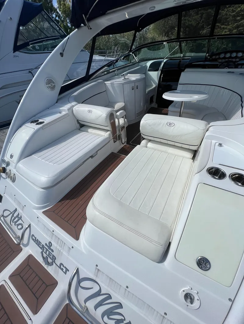 Slide: The Image of 2003 Cobalt 360 boat interior with white leather seating and wood flooring - 11