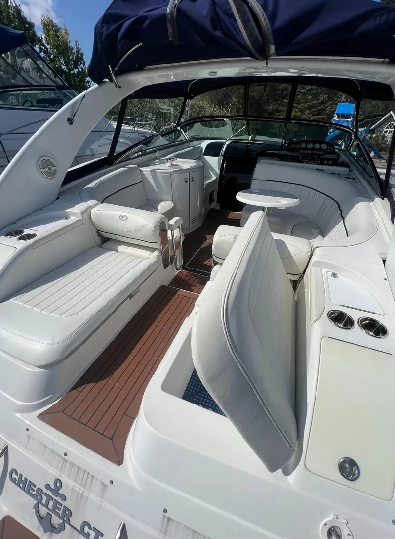 Slide: The Image of 2003 Cobalt 360 boat interior with white seating and wood flooring. - 12