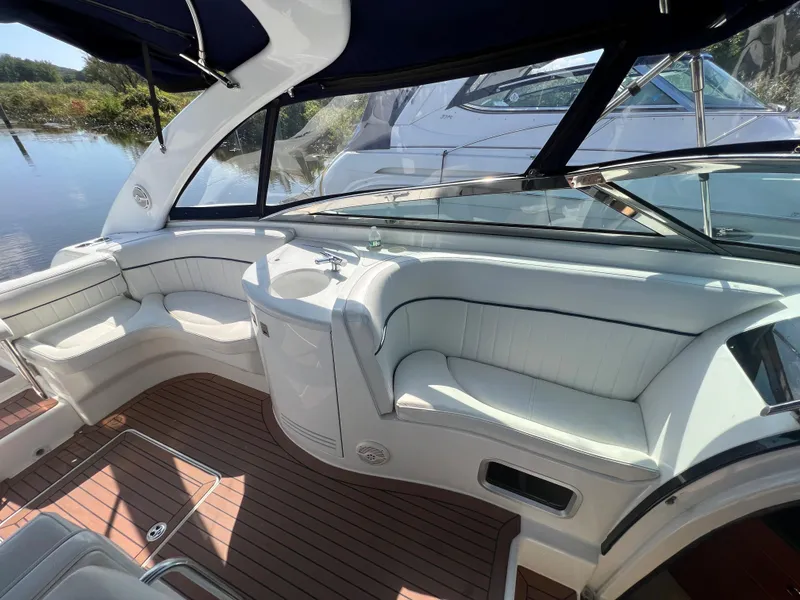 Slide: The Image of 2003 Cobalt 360 boat interior with white seating and wooden flooring. - 18