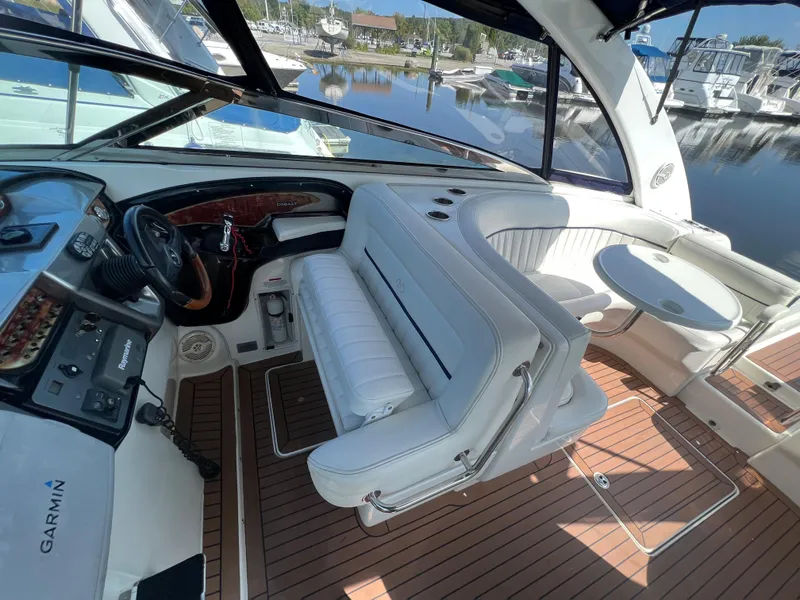 Slide: The Image of Interior of 2003 Cobalt 360 boat with white seating and wooden flooring. - 19