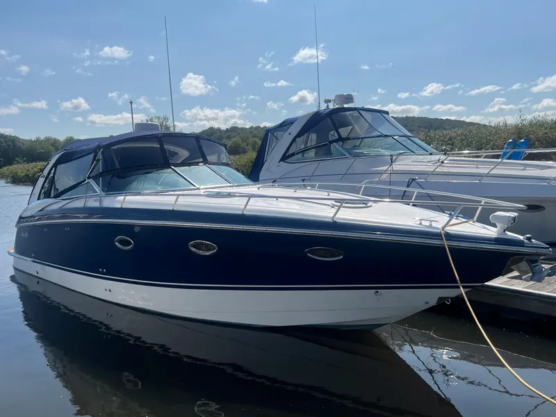 Slide: The Image of 2003 Cobalt 360 boat docked in marina on a sunny day. - 2