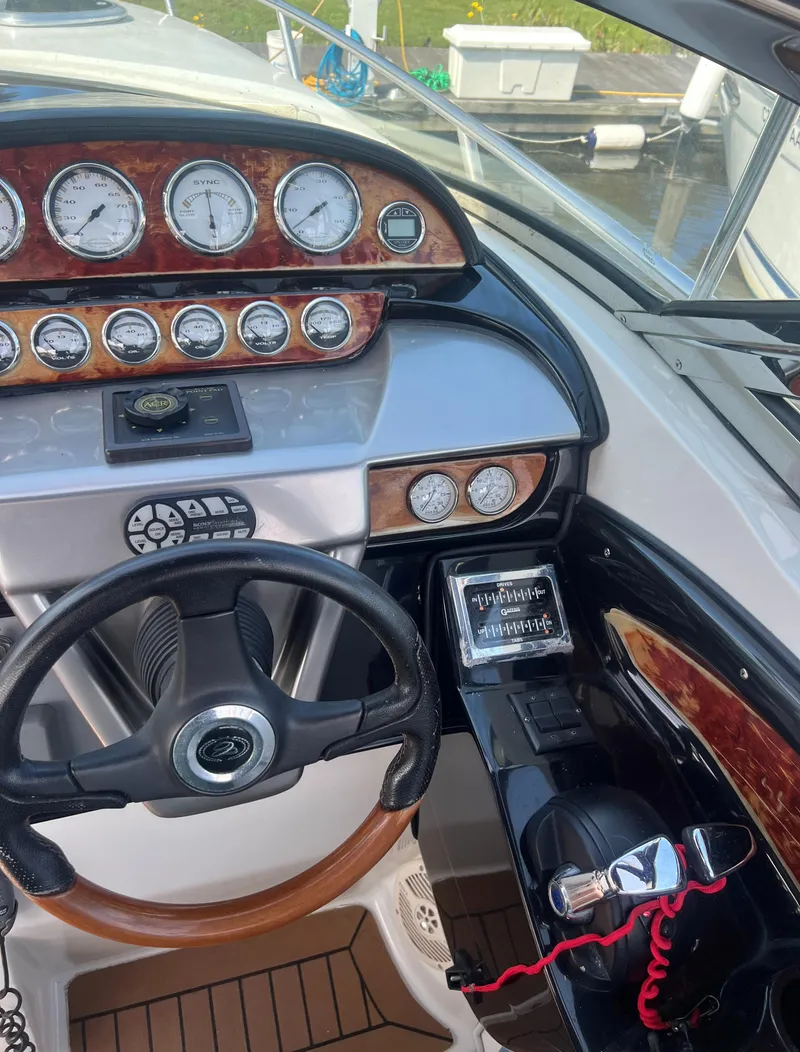 Slide: The Image of Control panel of a 2003 Cobalt 360 boat with wood trim and multiple gauges. - 21