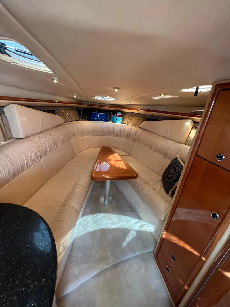 Slide: The Image of Luxurious interior of a 2003 Cobalt 360 yacht with plush seating and wooden table. - 26