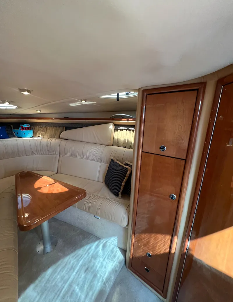 Slide: The Image of Interior of 2003 Cobalt 360 yacht with beige seating and wooden cabinetry. - 27