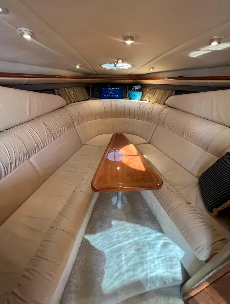 Slide: The Image of Luxurious interior of a 2003 Cobalt 360 yacht with plush seating and wooden table. - 29