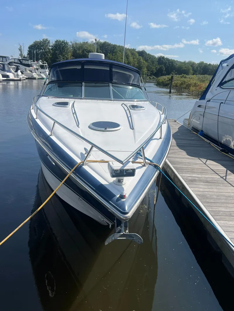 Slide: The Image of 2003 Cobalt 360 boat docked at a marina on a sunny day. - 3