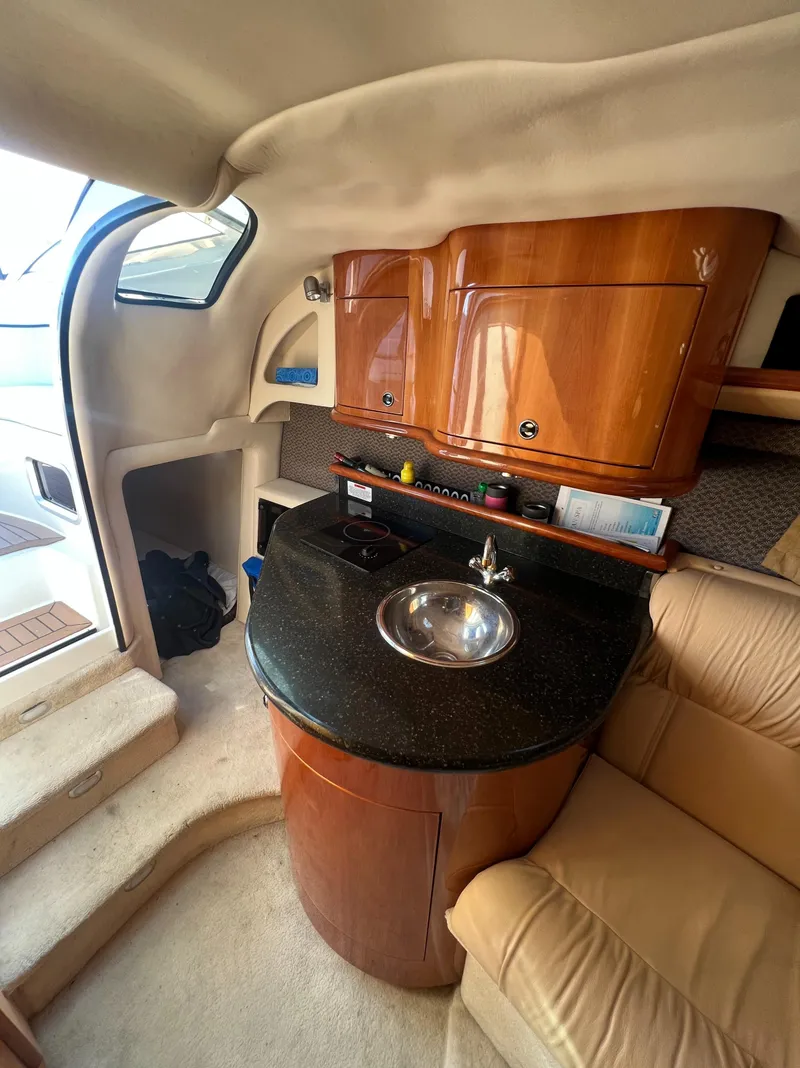 Slide: The Image of 2003 Cobalt 360 yacht interior with kitchenette and seating area. - 30