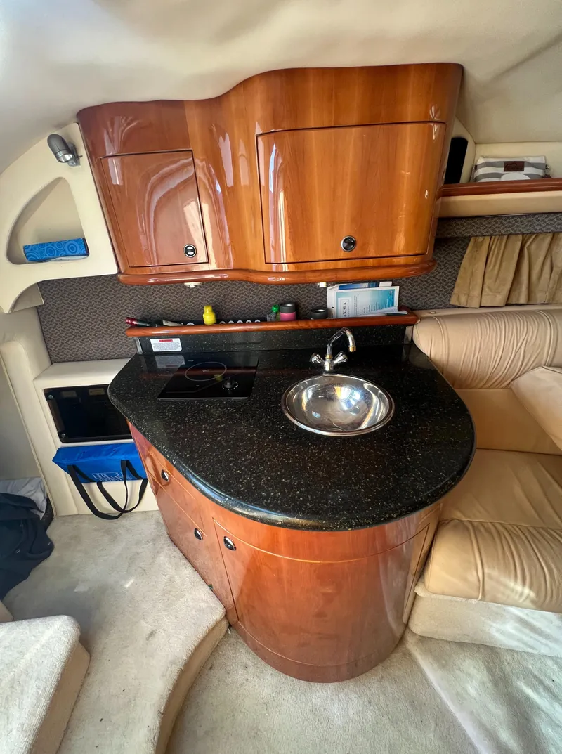 Slide: The Image of Luxurious 2003 Cobalt 360 yacht interior with kitchenette and wooden cabinetry. - 31