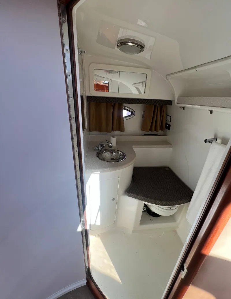 Slide: The Image of Compact bathroom in 2003 Cobalt 360 boat with sink, mirror, and toilet. - 37